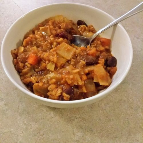 Cabbage roll soup in a white bowl.