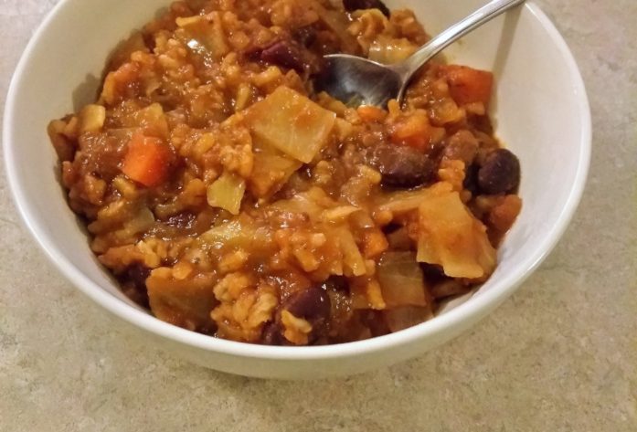 Cabbage roll soup in a white bowl.