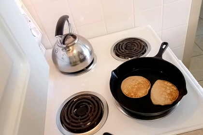 Easy Homemade Old-Fashioned Pancakes frying in a cast iron pan