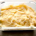 The BEST Mashed Potatoes in a clear glass container.