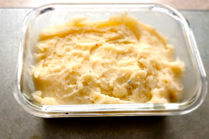 The BEST Mashed Potatoes in a clear glass container.