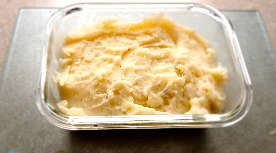 The BEST Mashed Potatoes in a clear glass container.